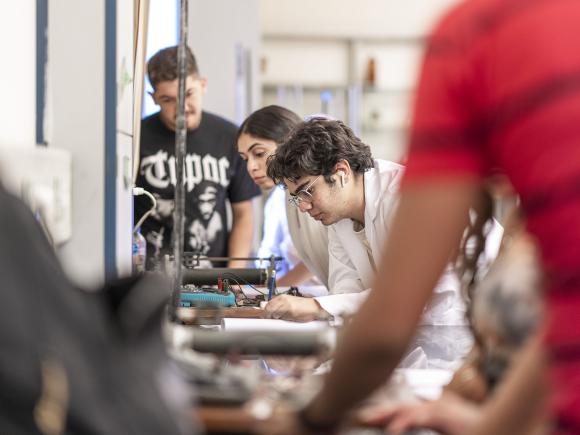 Students in a mechanical lab conducting experiments