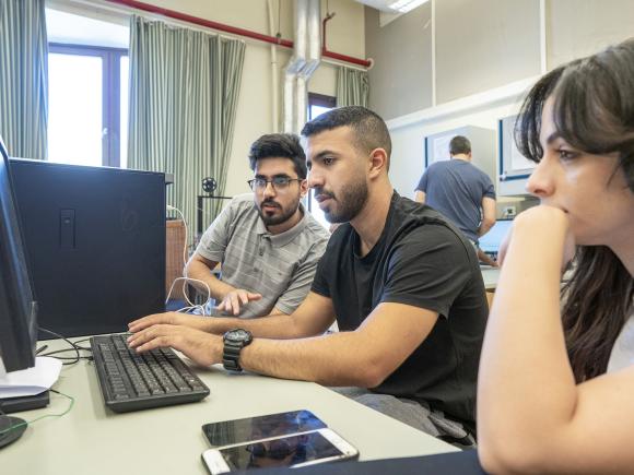 Students in computer lab writing on a keyboard