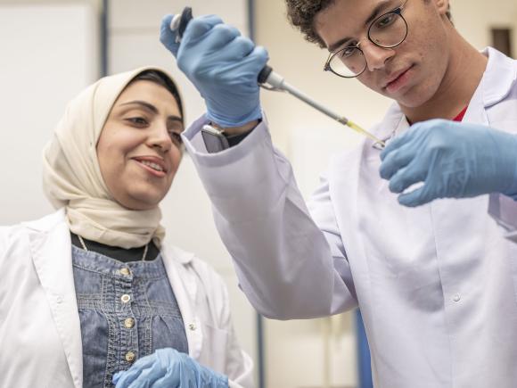 Instructor and a male student in a lab