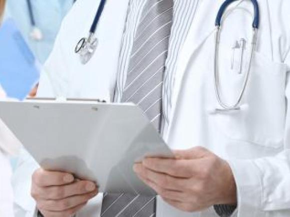 doctor holding a paper with wearing a tie