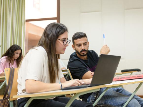 Economics Program image of female student discussing information with her group partner in class