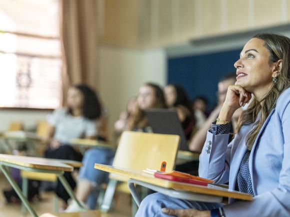 Smiling students in class attending