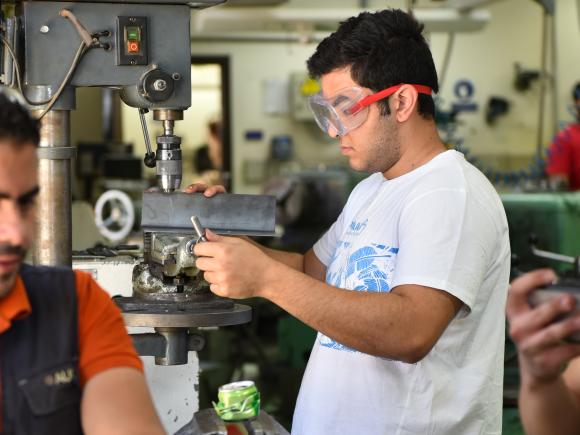 petroleum engineering program student working with machinery  in science lab