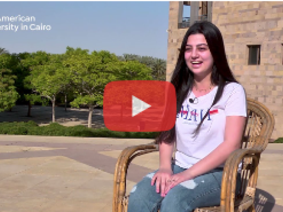 a girl wearing a white tshirt on a chair