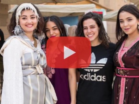 Four female students wearing ethnic clothing