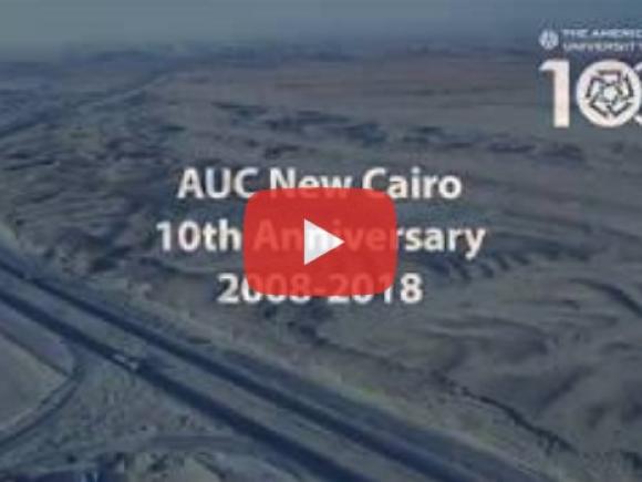 Building are in black and white, text reads "AUC New Cairo 10th Anniversary 2008-2018"