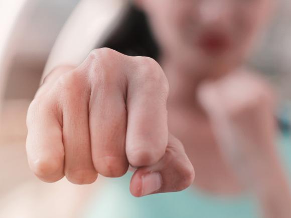 Blurry image of a girl pointing her fist
