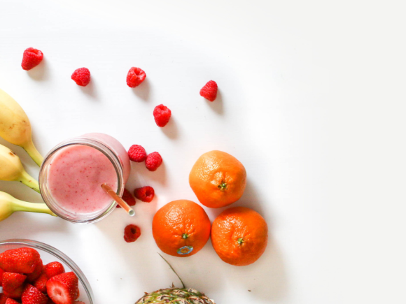 Picture with white background and fruits and a smoothie