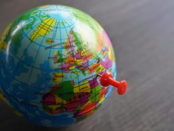 Picture of a side of a globe with a pin pointing to the Middle East