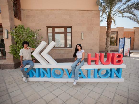 a girl and a boy sitting at the innovation hub