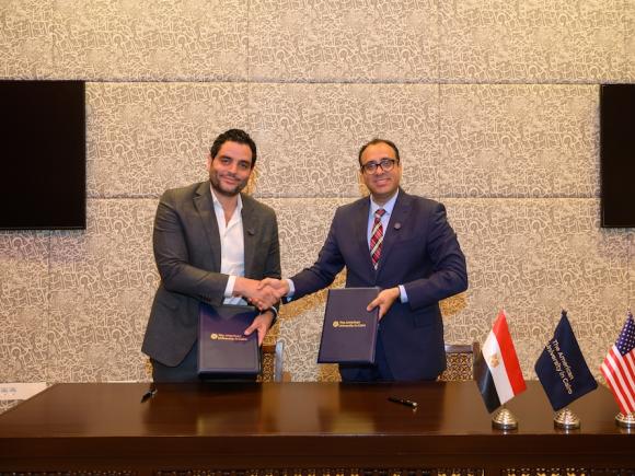 Two men shaking hands after signing agreement