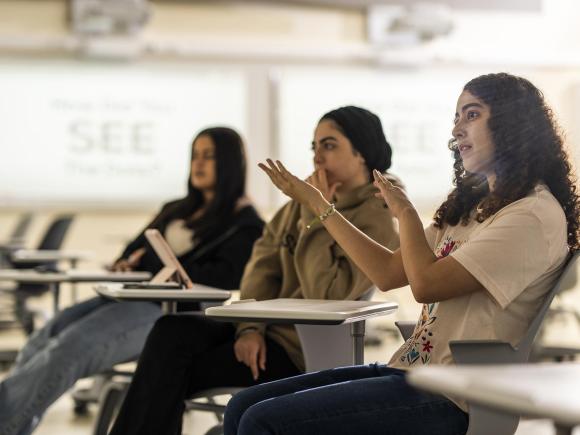 a female student engaging in a class discussion