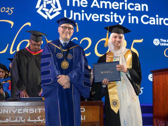 Female graduating senior with the President of the University