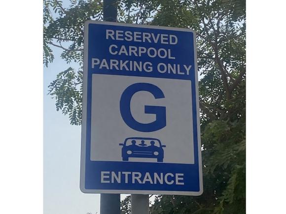 A sign that has a car icon. Text: Reserved Carpool Parking Only sign, G, Entrance