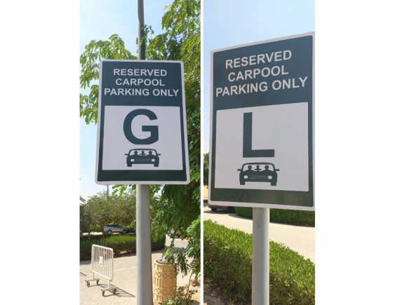 A sign that has a car icon. Text: Reserved Carpool Parking Only sign "G" and "L"