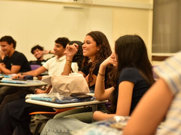 Students laughing in class and they seem happy.