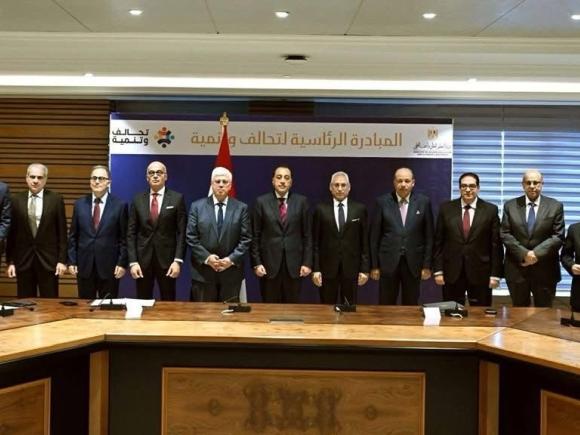 AUC President Ahmad Dallal, Professor Yehea Ismail and Hala Barakat are standing beside the Prime Minister and Minister of Higher Education and Scientific Research