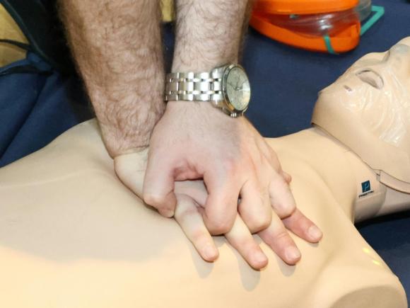 A man performing first aid on a manikin 