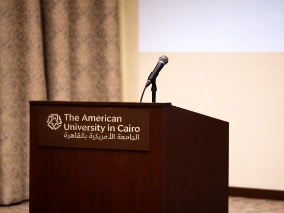 a mic on a podium and behind it a curtain