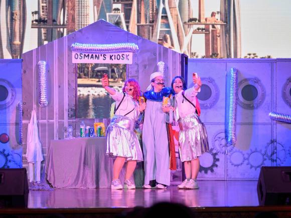 Three performers are on a stage