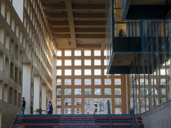 Outside the AUC Library with geometric windows, open staircases, and students walking through the space.