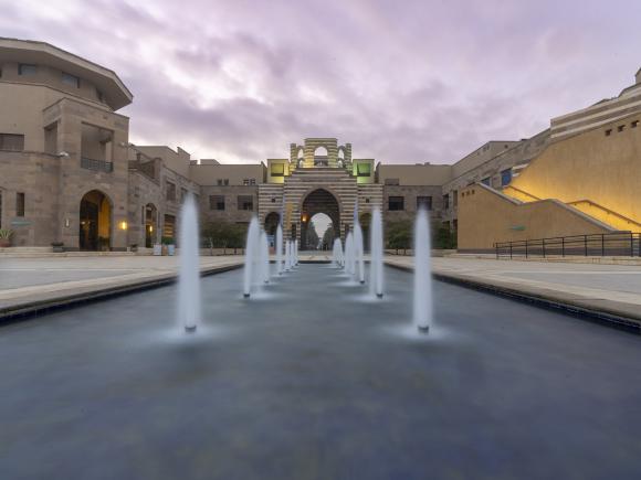 A big building with a fountain in front of it