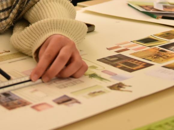 Student drawing on a sketch 