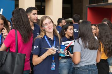 an international auc student with face paint