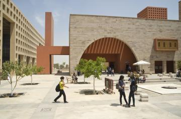 Students walking around the campus plaza