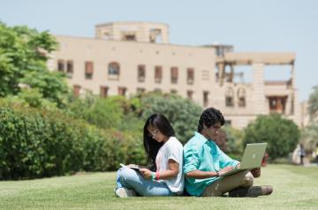 AUC students sitting in the campus garden. 