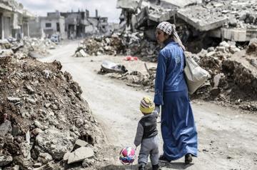 a woman and her child in a warzone