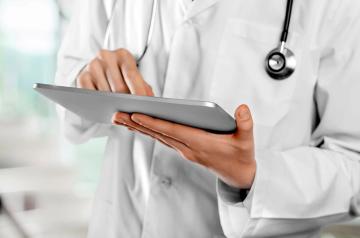 physician holding a tablet