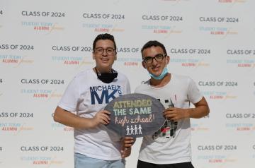 Two boys holding a sign