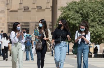 Four students/girls walking on campus
