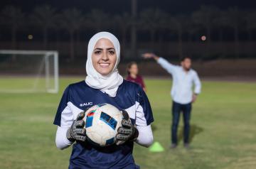 Veiled girl with football