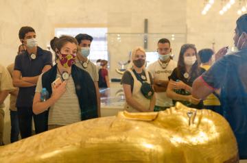 Group of students looking at a tomb at a museum