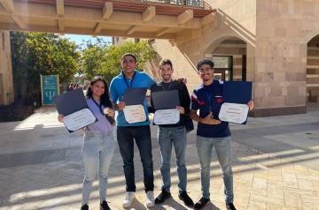Girl and boys holding certificate