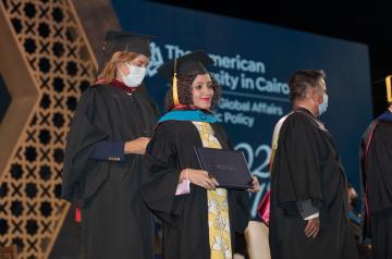 Girl with cap and gown holding a certificate
