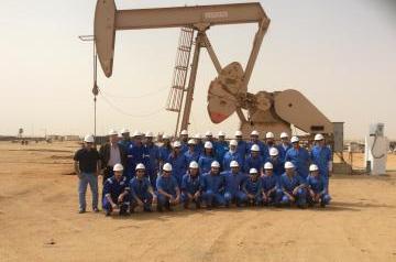 Students in front of oil drill