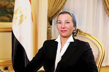 Woman sitting on a chair next to the Egyptian flag