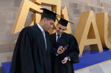 Two male graduates in their caps and gowns
