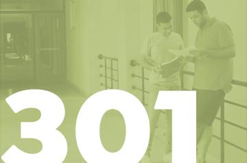 two boys studying together from a book. 301 written on the picture in white