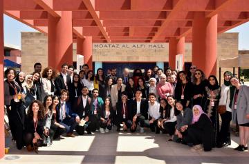 A group photo of TL students and staff with AUC President