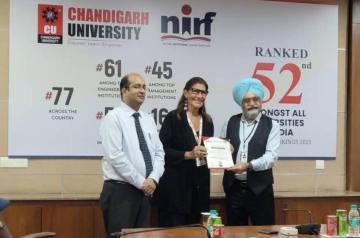 Chandigarh University, two men and a woman receiving an award