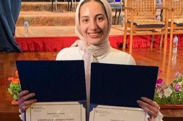 Girl holding two certificates