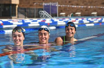 Girls smiling in athletic swimming pool
