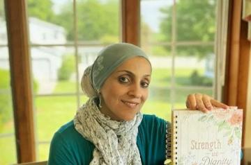 A veiled woman holding a book