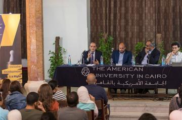 Four men sitting on a panel, The American University in Cairo, الجامعة الأمريكية بالقاهرة