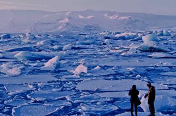Two people standing on ice