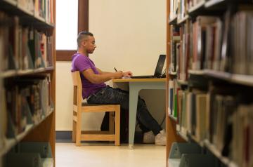 Male student studying in library